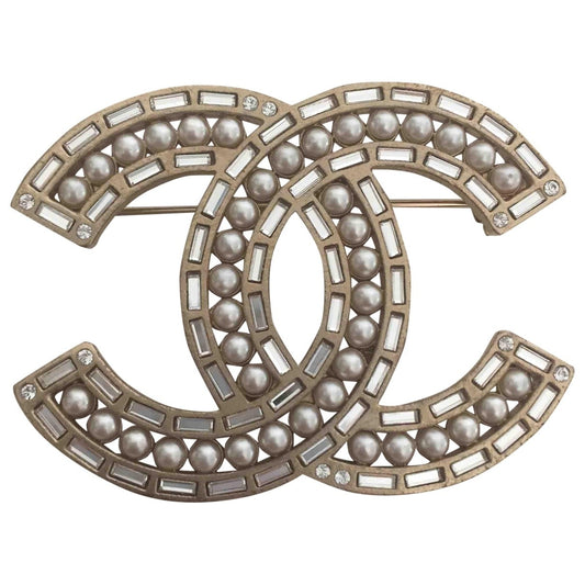Chanel cc gold metal pins & brooches