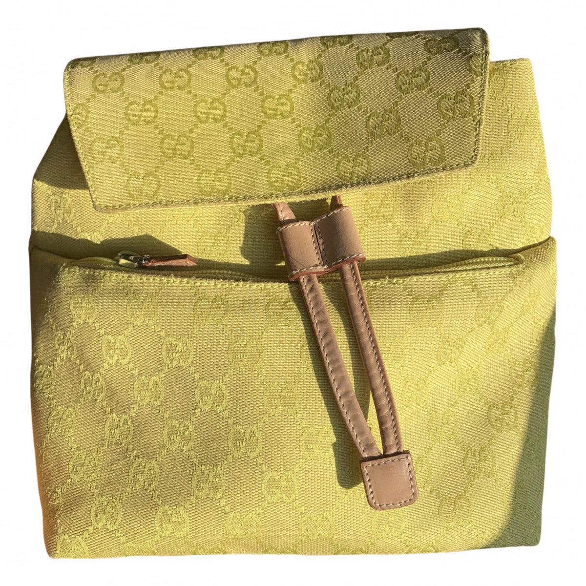 Gucci yellow cloth backpacks