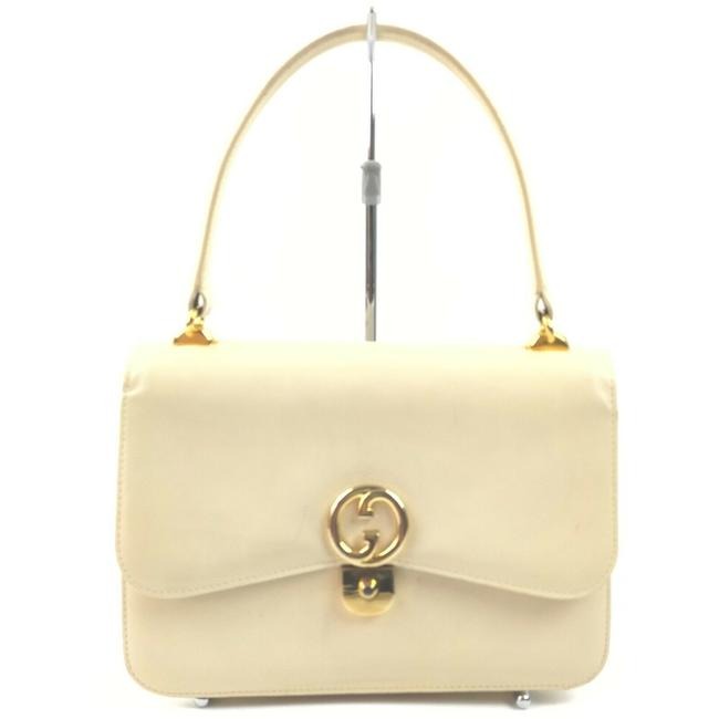 Vintage, Gucci, cream leather, 1973 top handle style purse with gold tone accents!