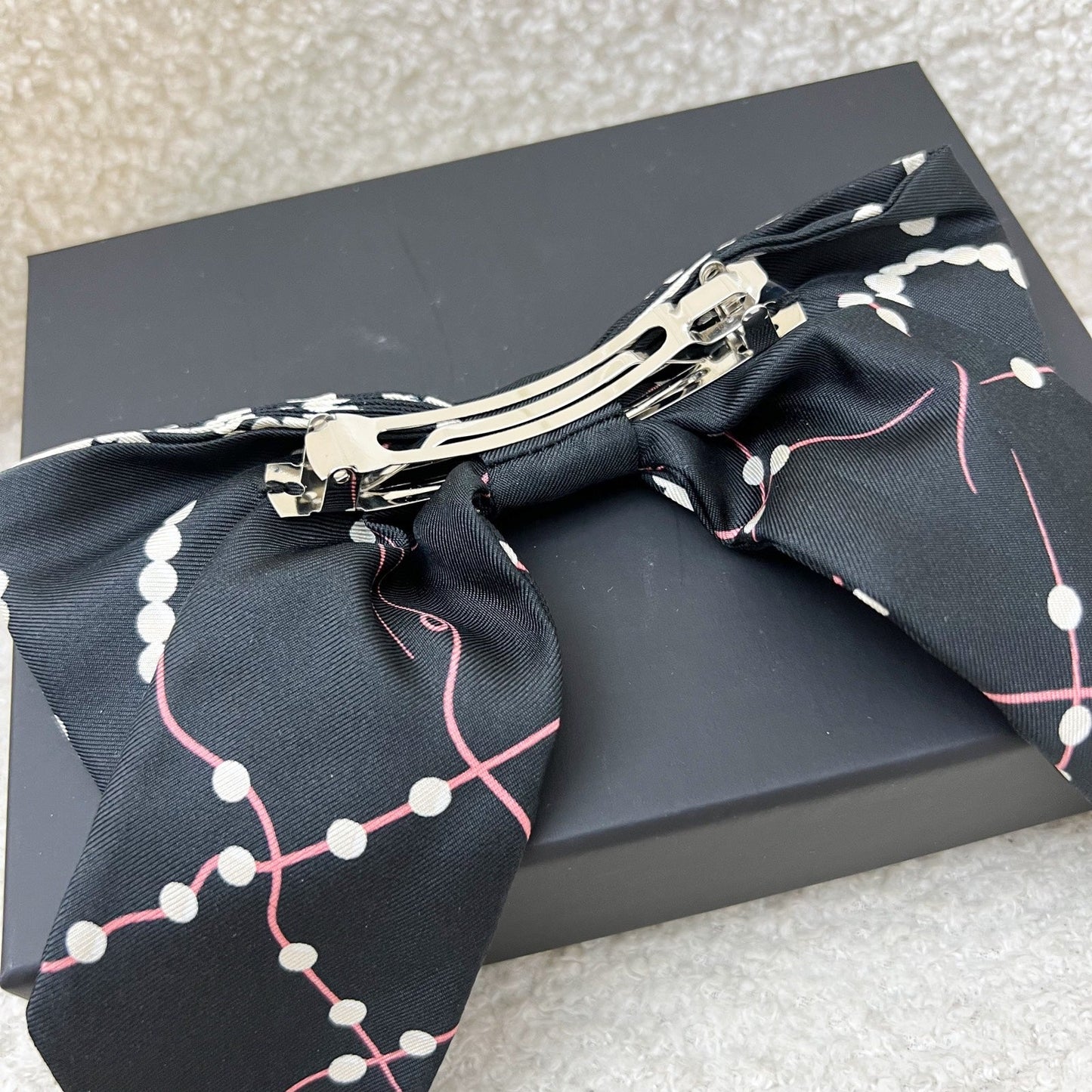 Chanel 23K Printed Pearl Motifs Bow Hair Clip in Black and Off White Fabric with Silver French Barrette