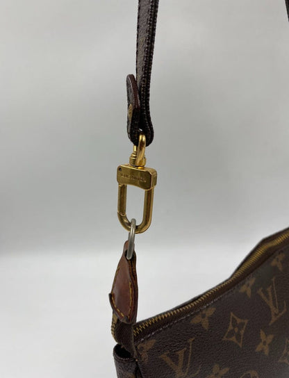 Louis Vuitton Pochette with crossbody strap.