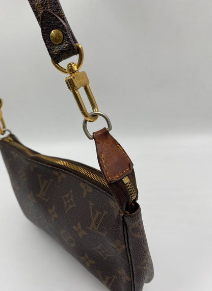 Louis Vuitton Pochette with crossbody strap.