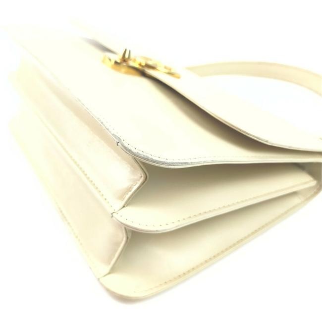 Vintage, Gucci, cream leather, 1973 top handle style purse with gold tone accents!