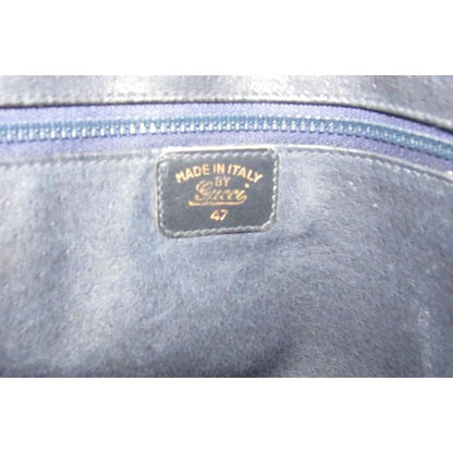 SALE! Vintage, Gucci, navy leather, shoulder bag with a zip top closure, front pocket, and a red and navy striped strap with gold horse-bit accents